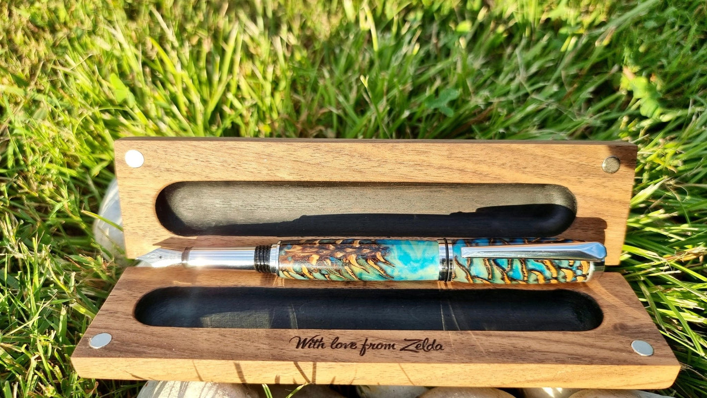 Handcrafted pine cone resin fountain pen resting on wooden box – one of a kind pen