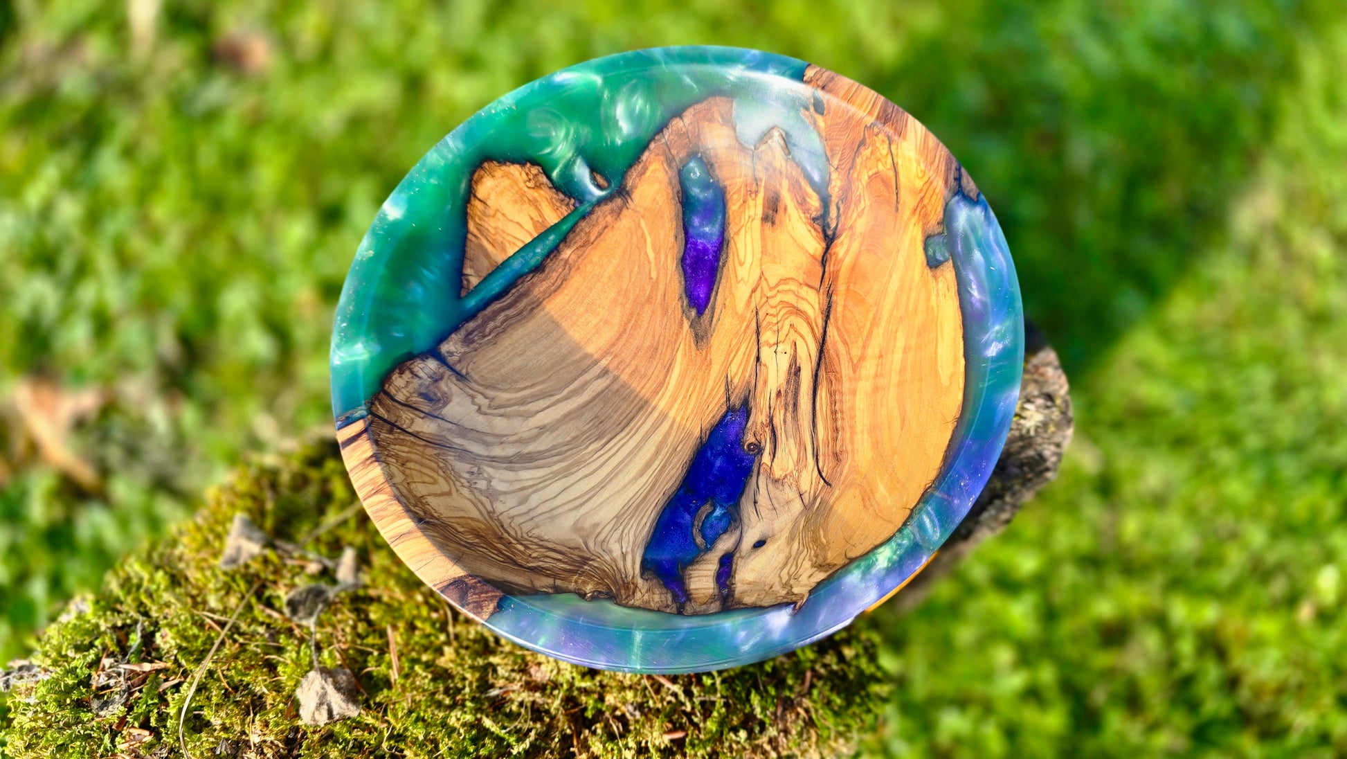 Artistic epoxy resin and olive wood bowl showing natural texture and color flow