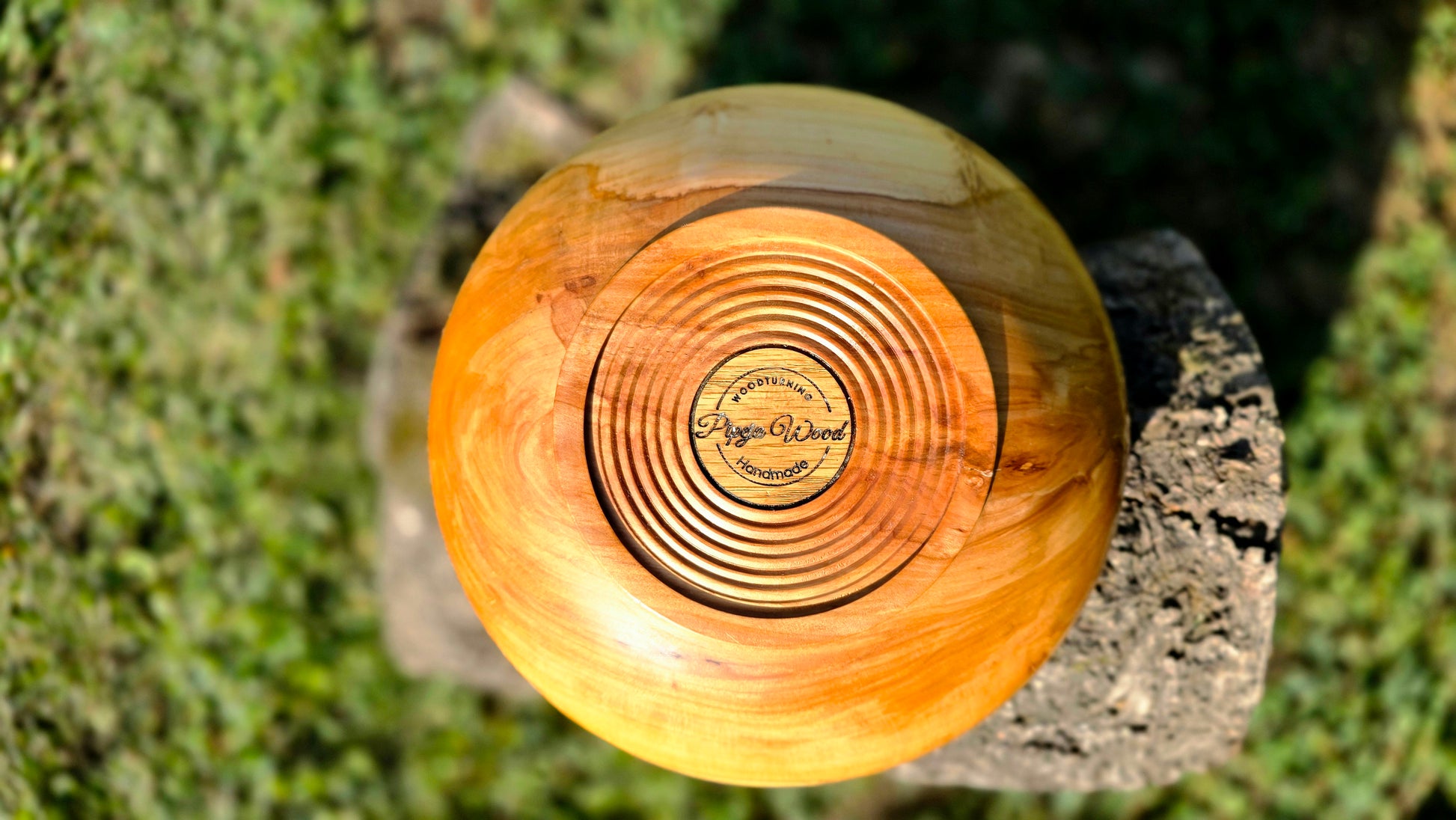 Handmade apple wood bowl showing warm honey grain and live edge