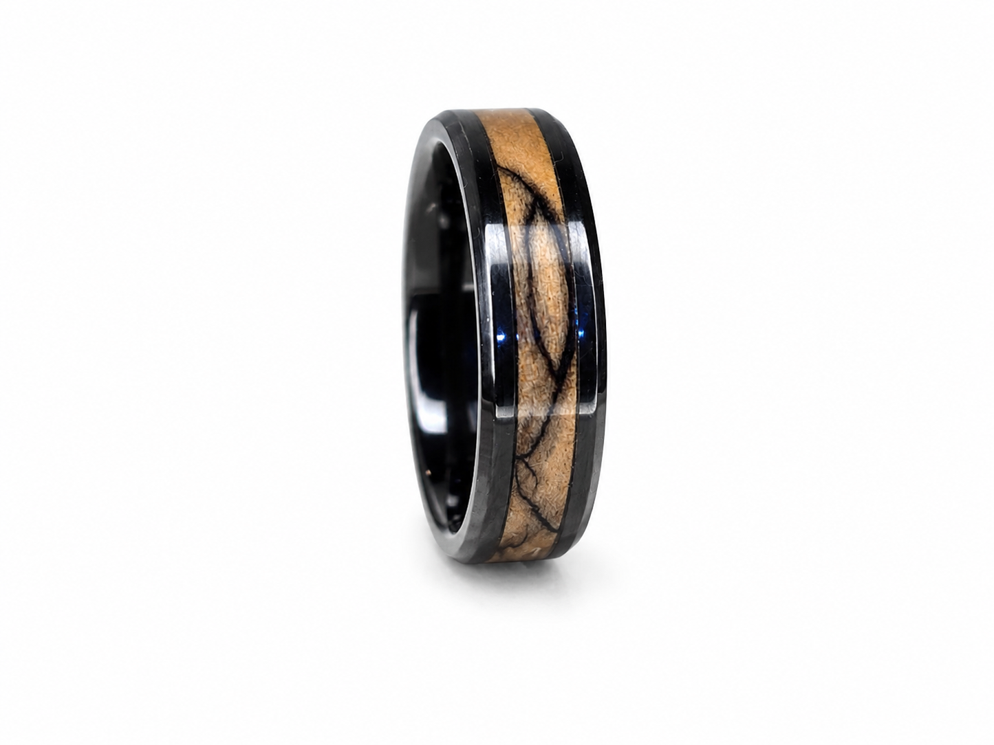 Close-up of handcrafted olive wood ring with blue pearl epoxy and ceramic inlay