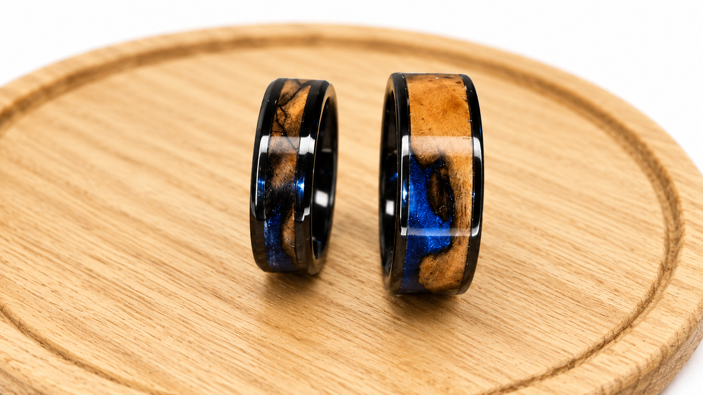 Handmade olive wood wedding rings with blue pearl epoxy resin and black ceramic core