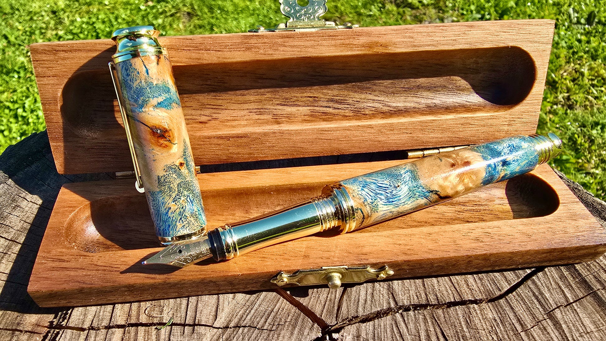 One of a kind handmade fountain pen from stabilized poplar burl wood and blue resin close up detail