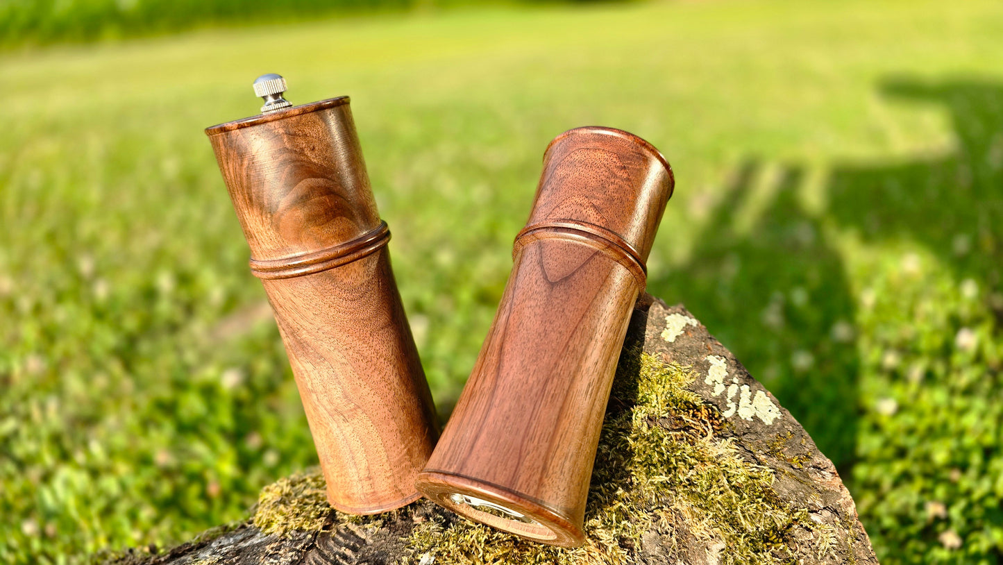 Close-up of wooden pepper and salt mills handcrafted from walnut wood