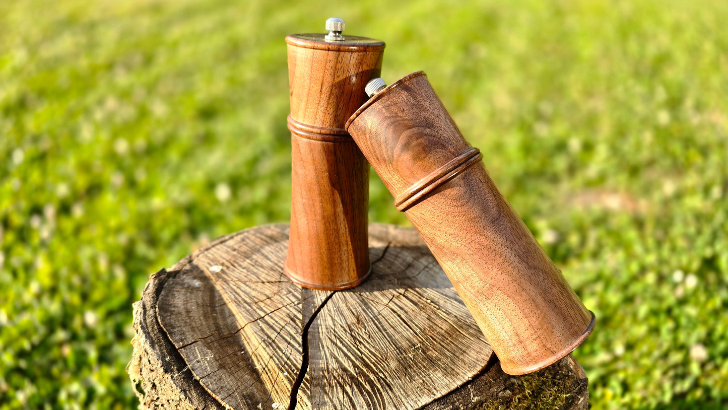 Rustic handcrafted pepper and salt grinders with natural wood grain and ceramic grinder