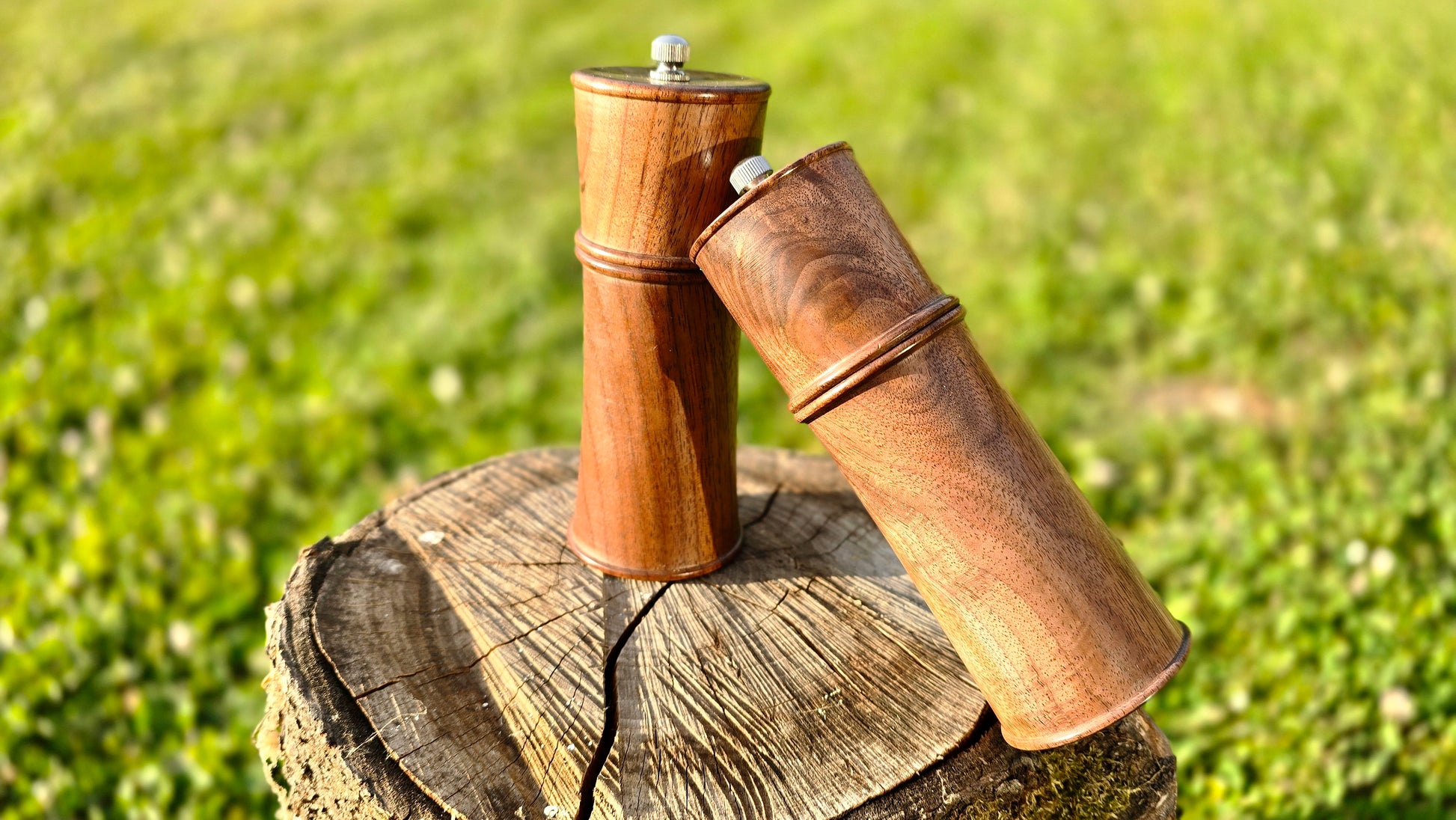 Rustic handcrafted pepper and salt grinders with natural wood grain and ceramic grinder