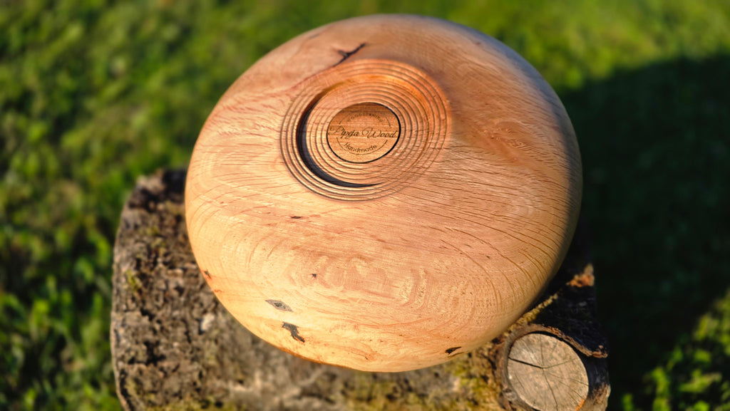 Wooden ball with a brand logo on a grassy background