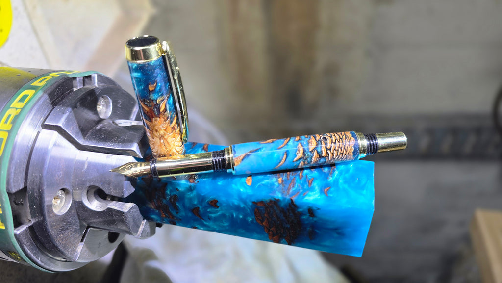 Close-up of polished resin and pine cone pattern on artisan fountain pen