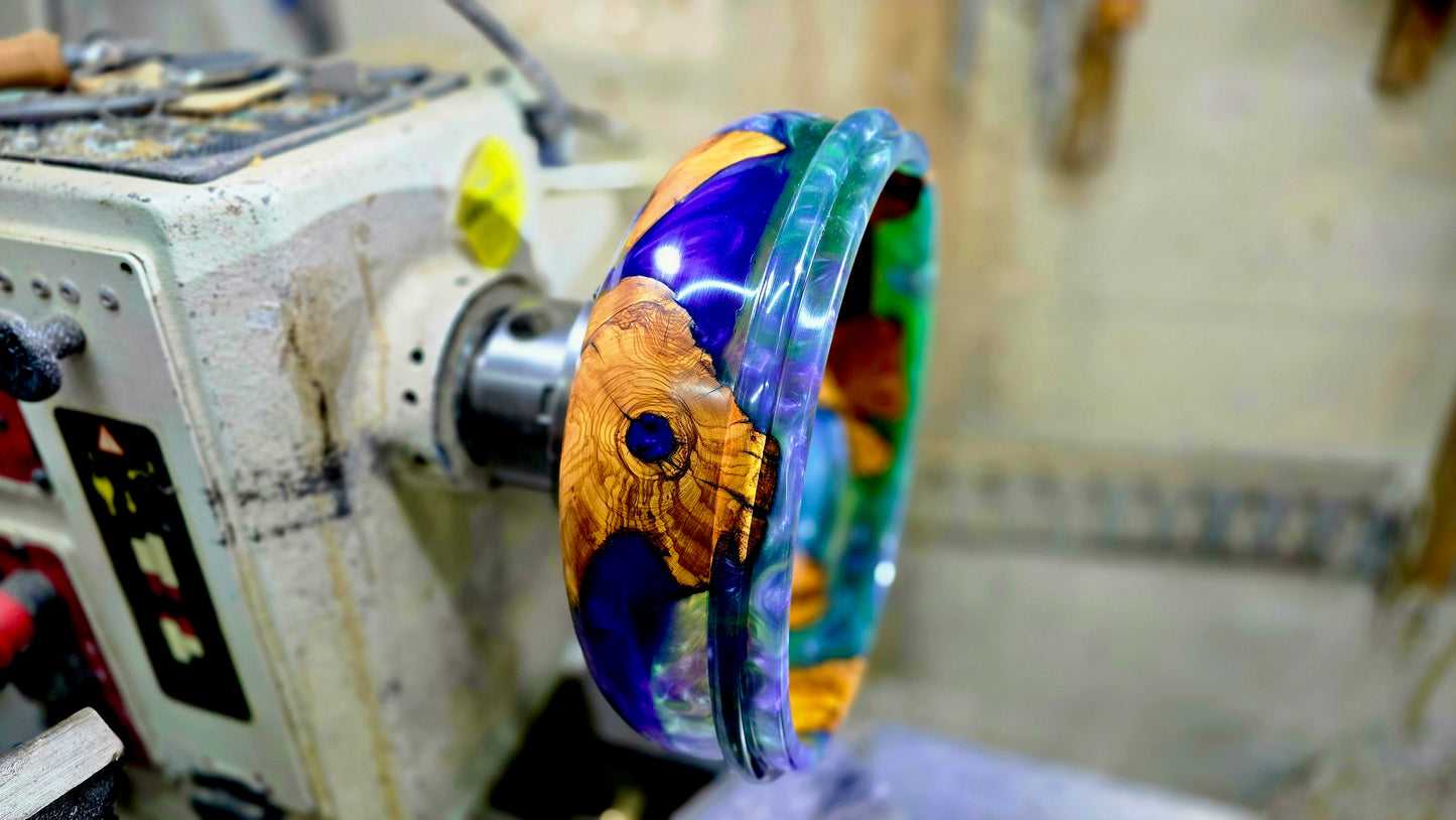 Olive wood epoxy resin bowl in progress on the lathe showing the handmade woodturning process