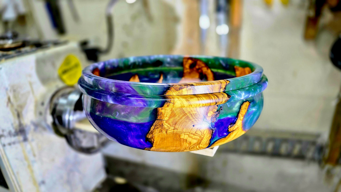 Side view of handmade olive wood epoxy resin bowl with organic shape and smooth finish