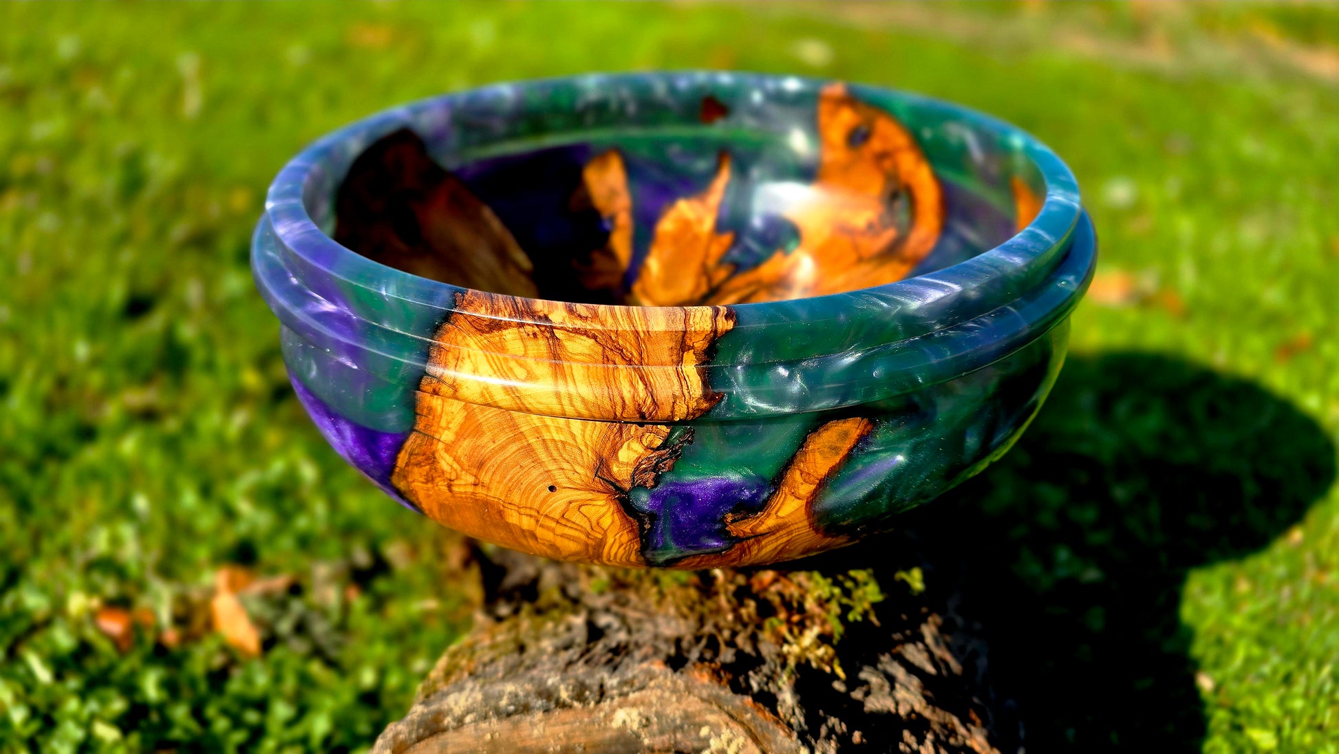 Close up of handmade olive wood epoxy resin bowl showing natural grain detail and glossy resin finish