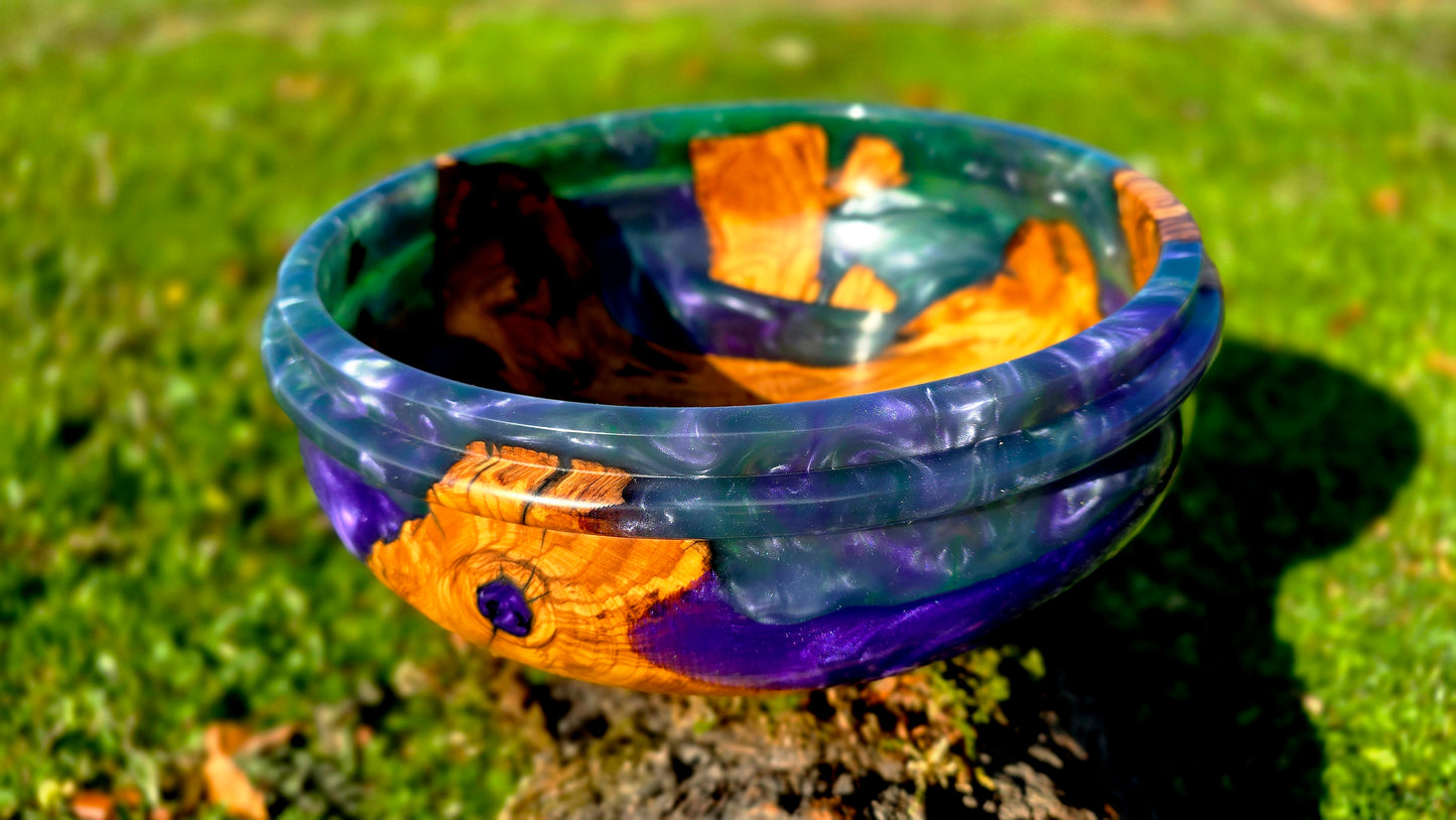 Luxury handmade epoxy resin and olive wood bowl used as decorative centerpiece in outdoor natural setting