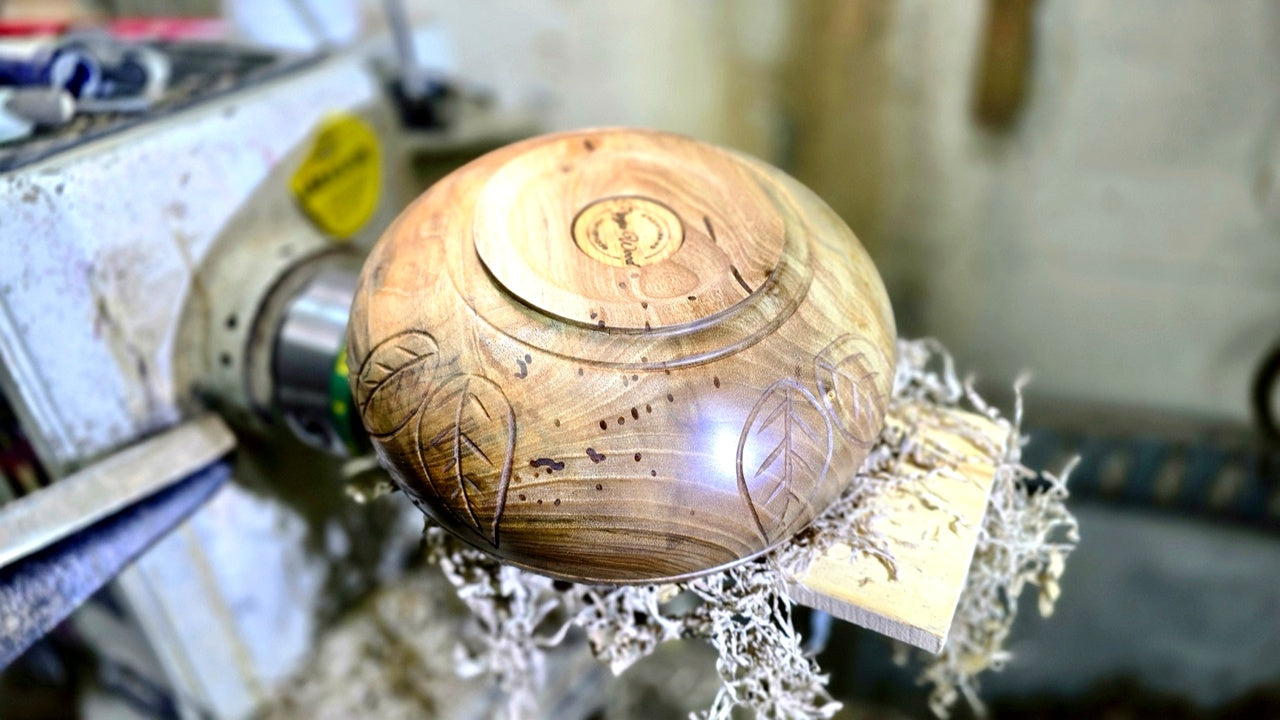 Bottom of handmade walnut wooden bowl with Pipejawood logo
