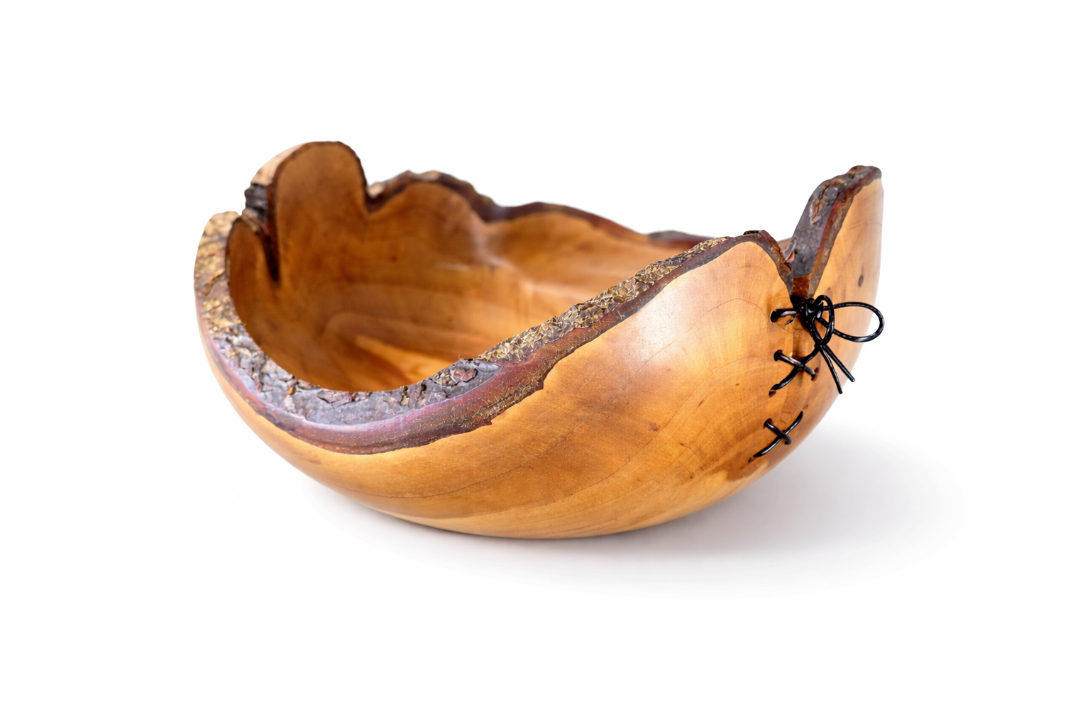 Wooden bowl with a natural edge design on a white background