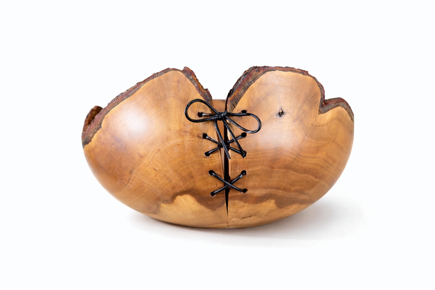 Wooden bowl with black laces on a white background