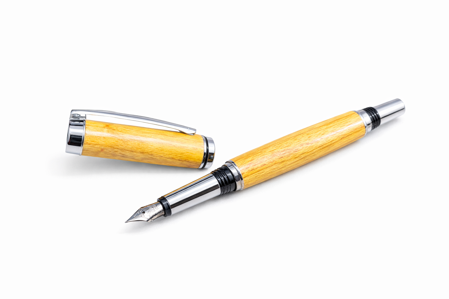 Wooden fountain pen with silver accents on a white background