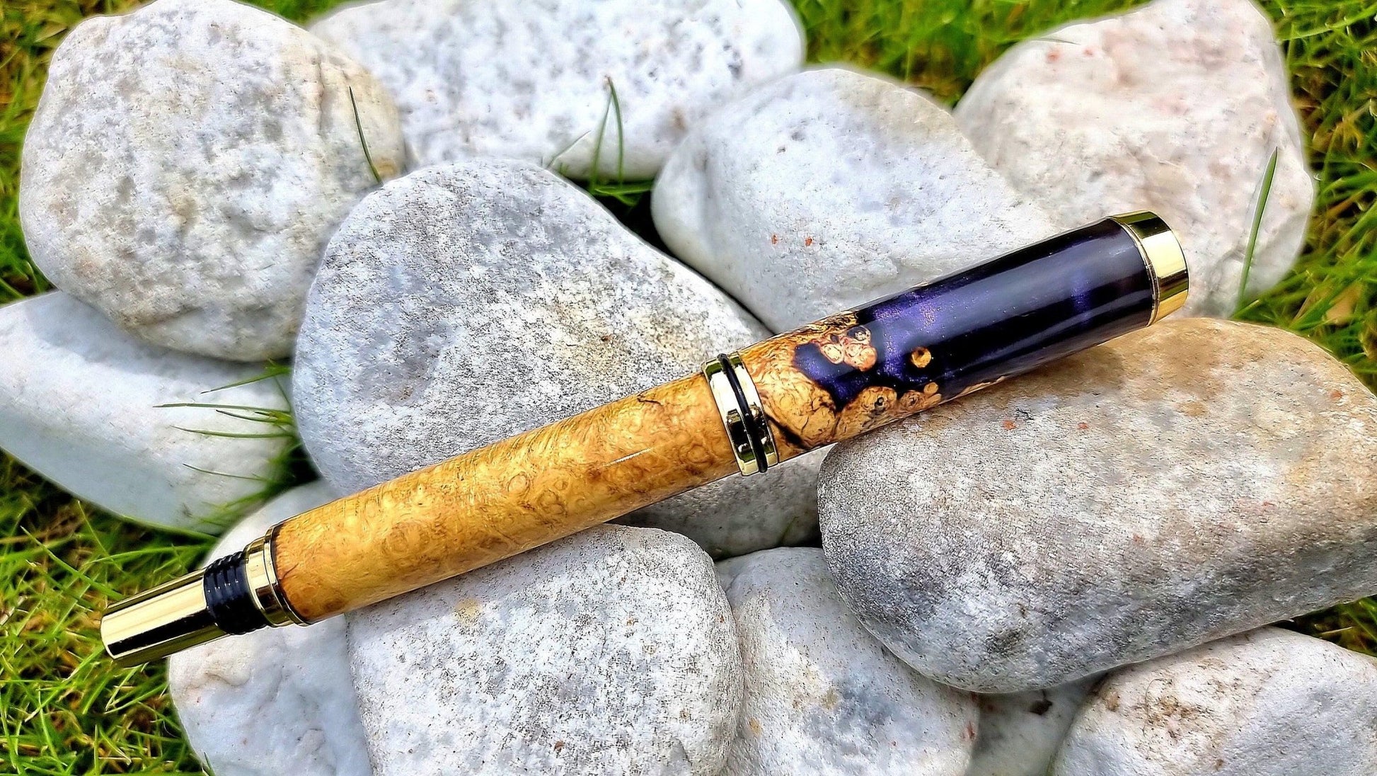 Luxury wooden fountain pen with acacia burl wood and epoxy resin close-up detail