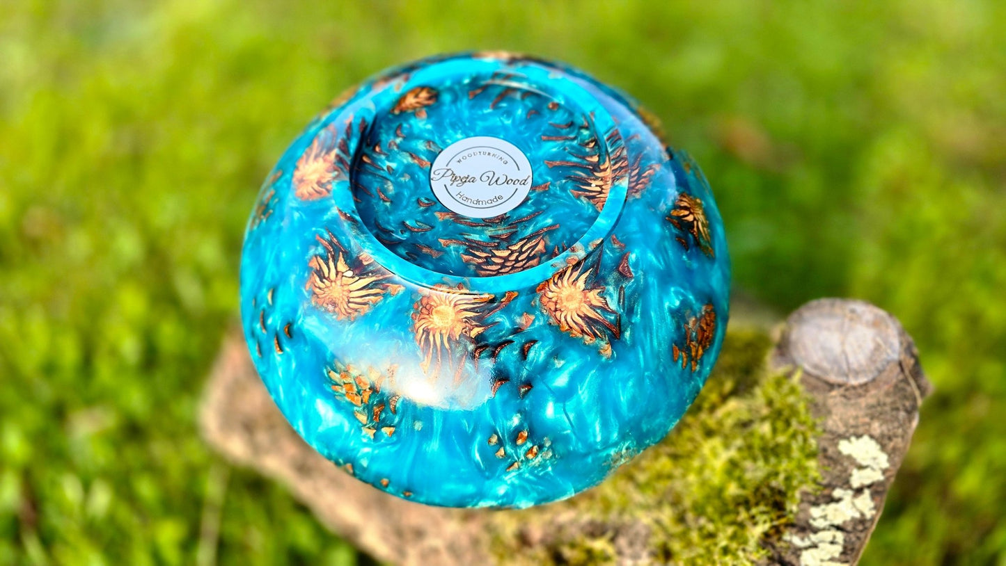 top view of handmade epoxy resin bowl with pine cones embedded in clear resin