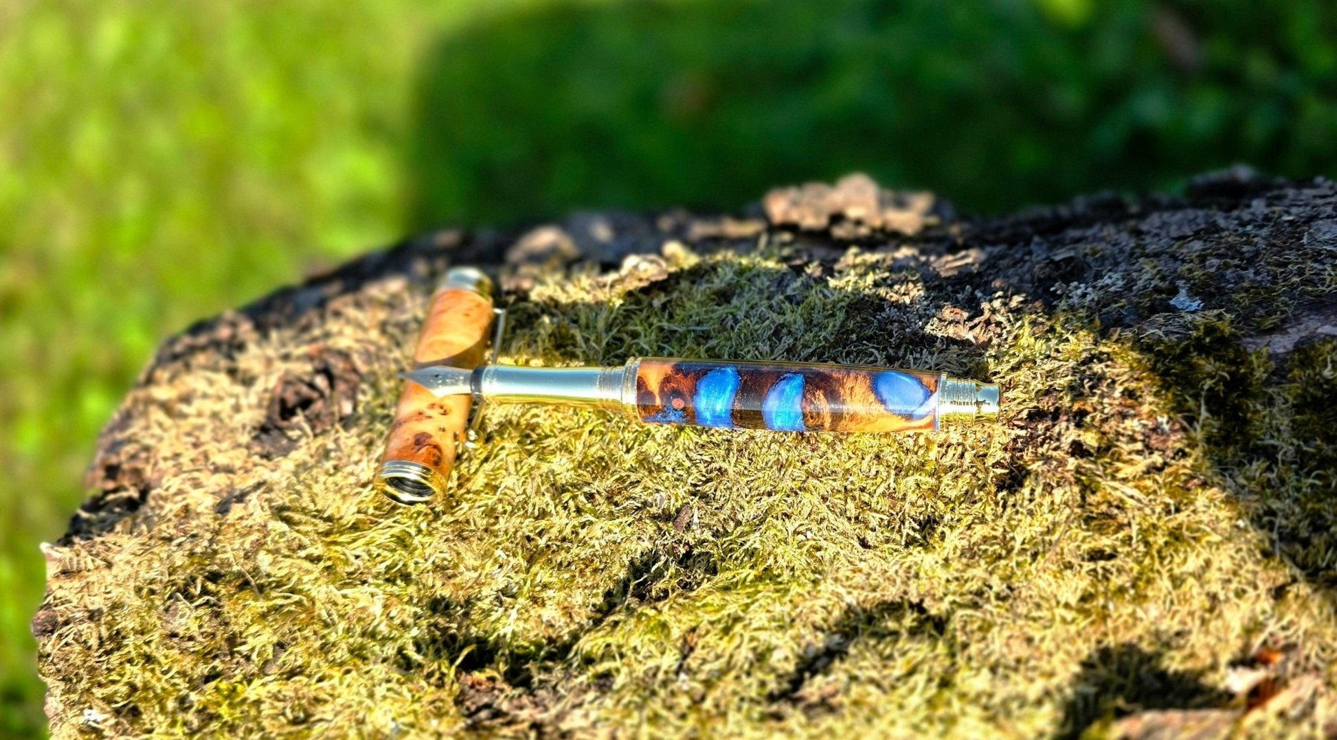 Luxury handmade fountain pen with natural poplar wood grain and shimmering blue epoxy resin close-up
