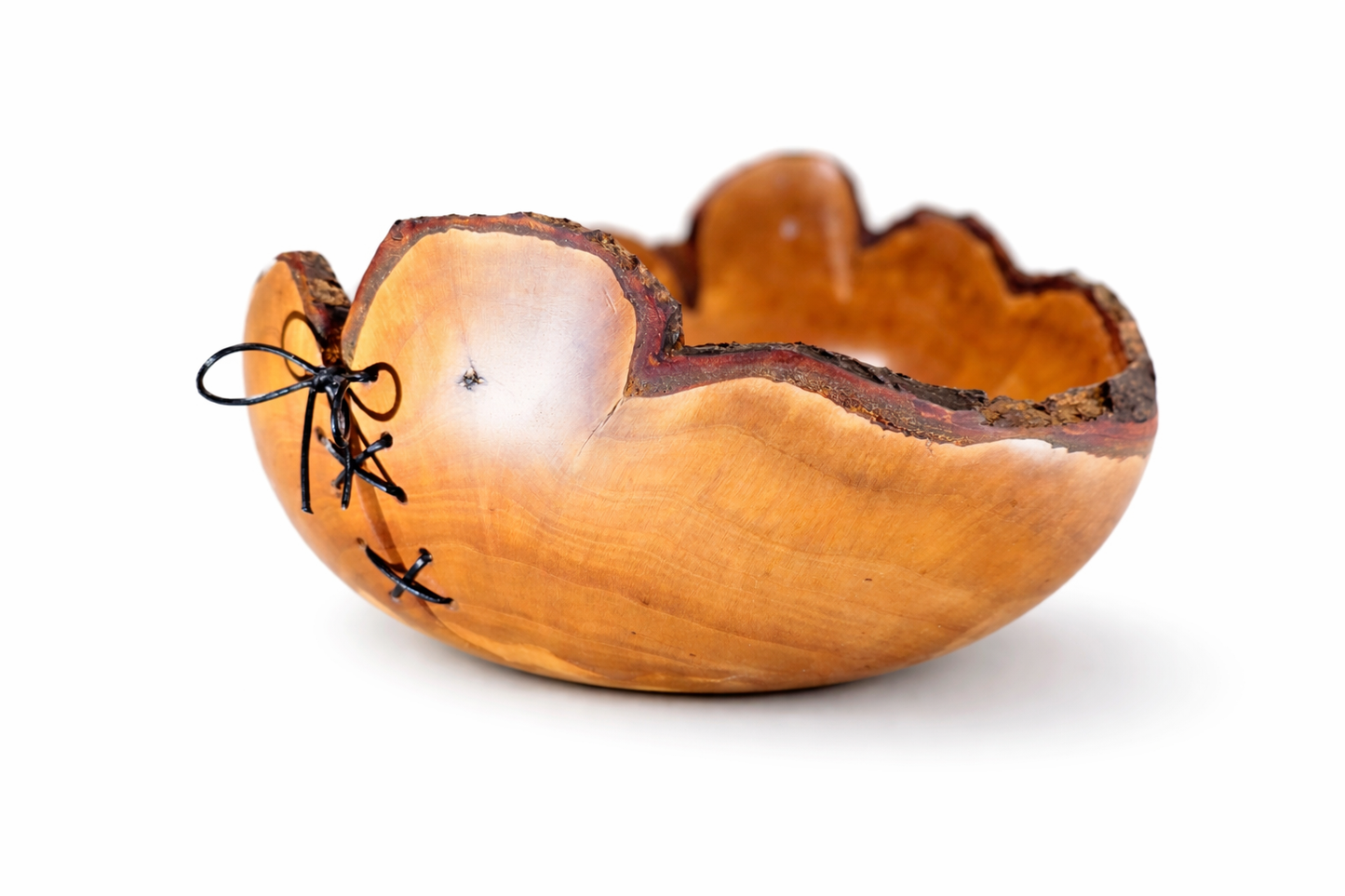 Wooden bowl with black decorative elements on a white background